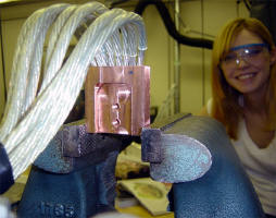 Lining up all the rail wires for soldering on the connector. Girlfriend in background :)