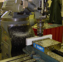 Machining smooth faces on the injector enclosure using a 3000RPM fly cutter.