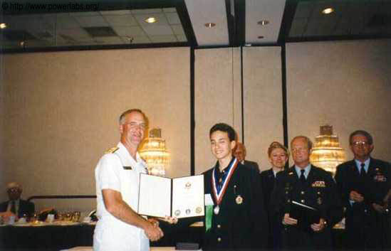 Sam receiving his science fair certificate in the US.