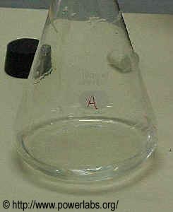 1000mL Pyrex Erlenmyer flask with a small amount of water in the bottom. The cork (black) sits in the background.