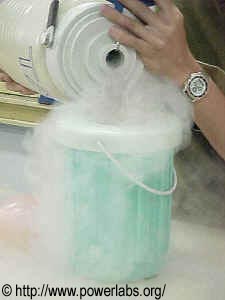 Liquid nitrogen being unloaded from the dewar flask into a larger recipient.