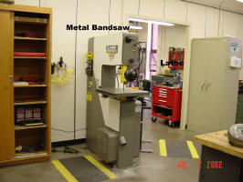 Metal Bandsaw and door leading to other metal workshop with a second lathe.