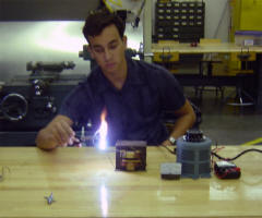 Sam watches an arc from the power supply.