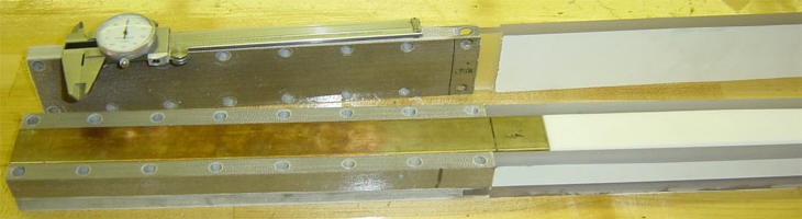 Top view of the Railgun and projectile injector with tops removed to show the copper and Teflon rails.